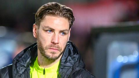 Sam Foley looks on during Barrow's defeat by Salford City