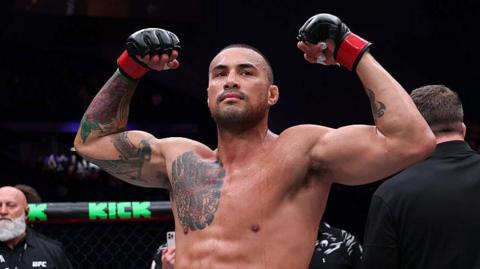 Carlos Ulberg celebrates after beating Dominick Reyes in September 2025