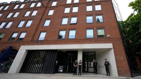 Police officers outside No 10 North, located in Heron House, central Manchester.