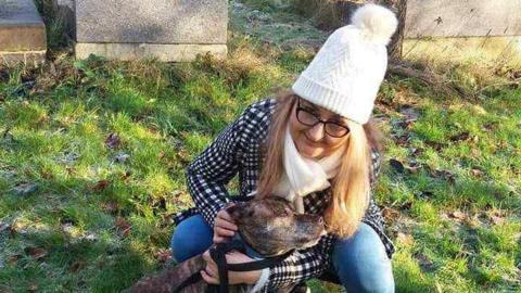 A family handout photo of Izabela Chalastra cuddling a dog.