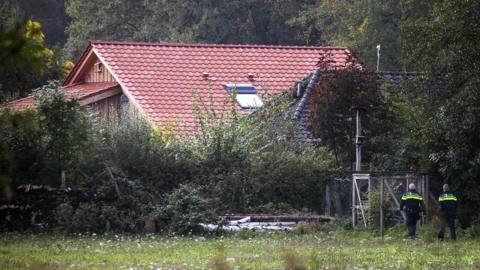 Police inspect the area of a farmhouse in Drenthe, the Netherlands, 16 October 2019