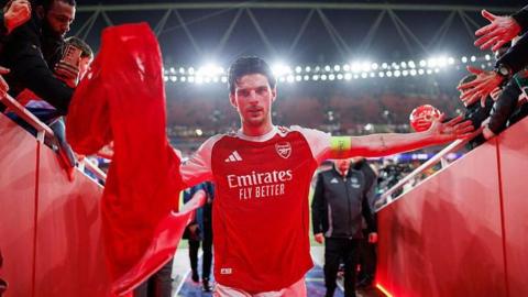 Declan Rice leaves the pitch and walks down the tunnel with arms outstretched as Arsenal fans reach out to him