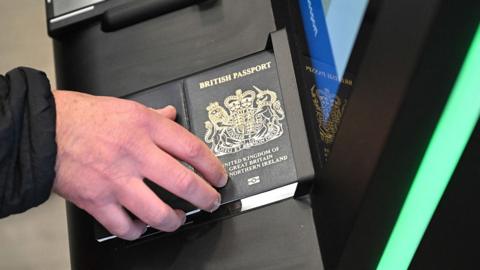 A person as their passport scanned whilst using an Automated European Union Entry/Exit System (EES) kiosk during a press preview on the rollout of the EU's new Entry-Exit System (EES) at Eurotunnel, south east England on September 23, 2025. 
