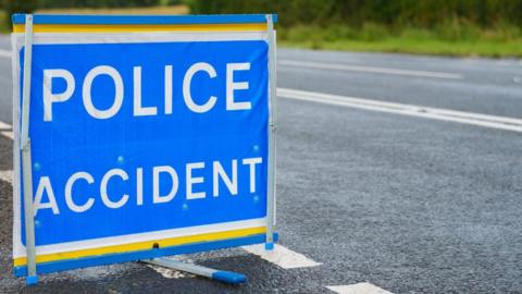 A blue sign stating 'Police: Accident' 