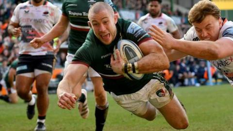 Leicester Tigers player Mike Brown dives over the line for a try against Saracens