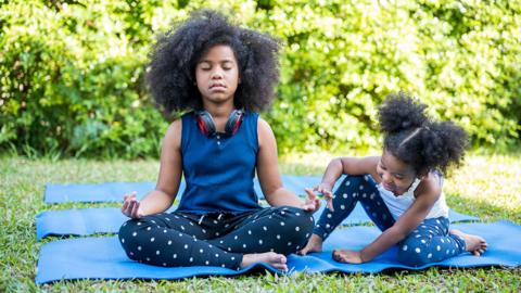 Two girls are doing yoga poses and meditation