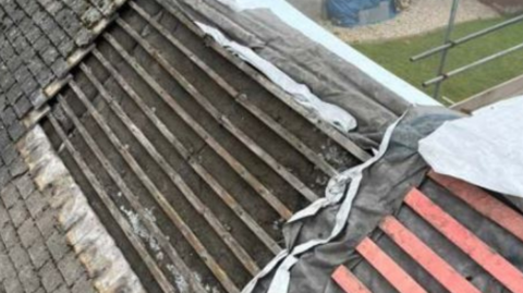 Swathes of tiles missing on the roof of a house 