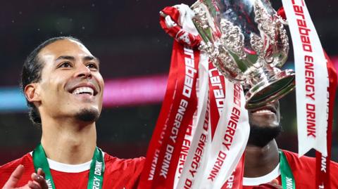 Liverpool's Virgil van Dijk celebrated with the EFL Cup trophy