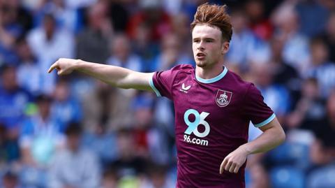 Tommy McDermott in action for Burnley during a pre-season friendly against Huddersfield