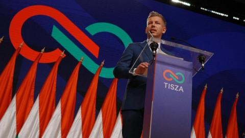 A man stands at a podium