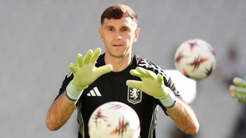 Emi Martinez catches a ball during a training session