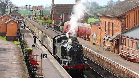 Steam train going through West Somerset Railway line.