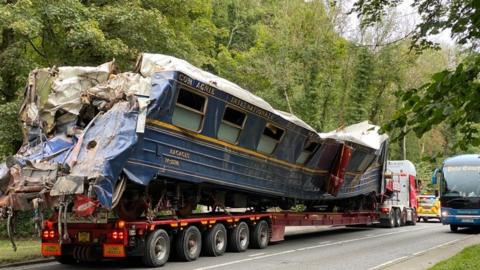 Damaged train carriage being removed from the Mission: Impossible set