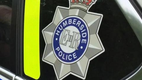Humberside Police badge on a police car