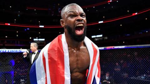 Darren Stewart celebrates a win with the UK flag draped over him