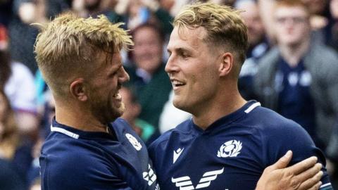 Scotland players Ben Healy and Duhan van der Merwe celebrate the latter's try against Georgia