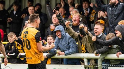 Leamington players celebrate with their fans