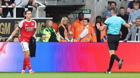 Riccardo Calafiori stopped by referee while holding a towel