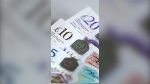 £5, £10 and £20 notes laid out together