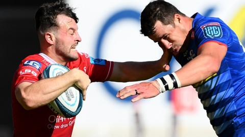 Ryan Conbeer of Scarlets is tackled by Manie Libbok