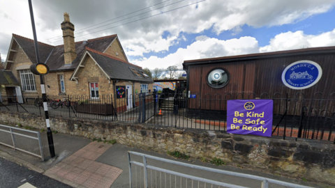 Street view of Morda Primary School, showing the original brick building, a modern demountable and the pedestrian crossing outside