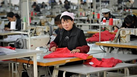 A woman works at a garment factory in China in 2010