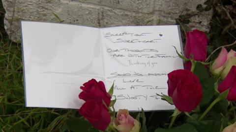 Floral tribute - flowers and a sympathy card signed near the scene of the fatal incident, North Yorkshire, England: 