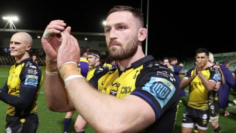 Harri Keddie of Dragons walking on a pitch at full time