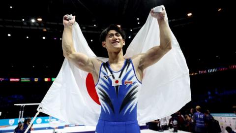 Daiki-Hashimoto-holding-flag.