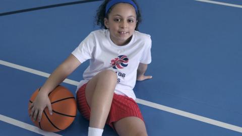 Dora McHardy with a basketball