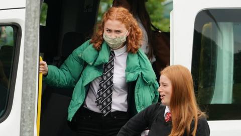 School children get off a bus in the Borders