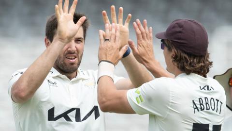 Surrey's Jamie Overton (left) and Sean Abbott celebrate a wicket