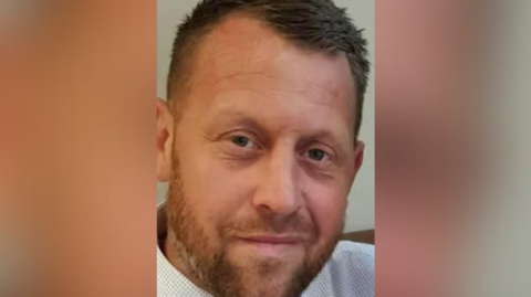 A photograph of Gareth Roper, who has brown hair and a light beard.