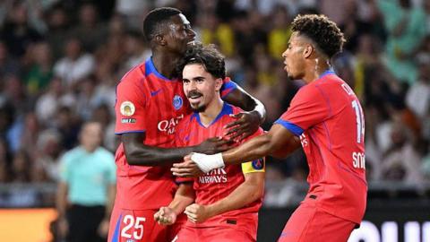 Vitinha celebrating with PSG team-mates Nuno Mendes and Desire Doue