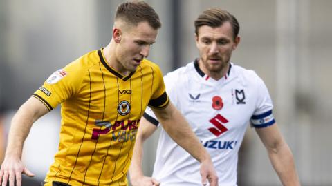 Bryn Morris of Newport County in action against Alex Gilbey