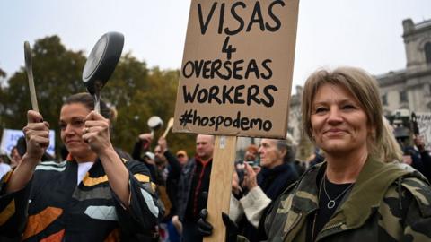 Hospitality workers demonstrate outside Parliament