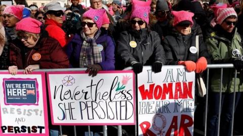 Women wearing pink pussy hats at a march