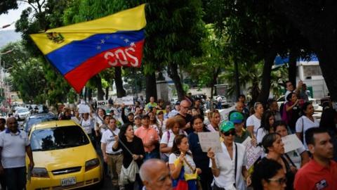 Medical personnel, parents and patients of the Jose Manuel de los Rios Hospital take part in a protest due to the death of the fourth child in a month, in front of the institution in Caracas, on May 29, 2019. (