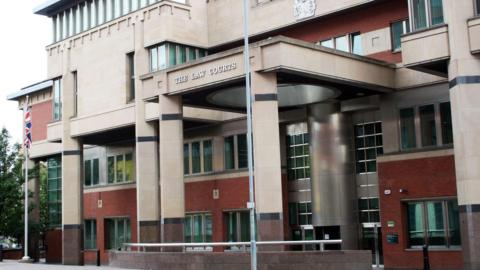Sheffield Crown Court. A large, modern court building built of red brick and pale stone. 