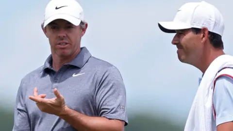 Rory McIlroy talking with his caddie Harry Diamond during round two of the US Open