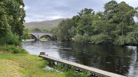 River Farrar with a bridge, trees a wooden walkway