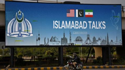 A billboard announces peace talks is Islamabad