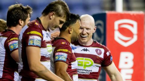 Bevan French celebrates his try with Wigan teammate Liam Farrell