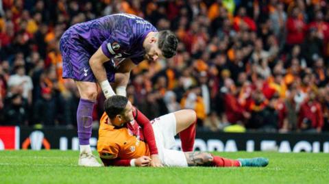 Tottenham keeper Fraser Forster checks on Mauro Icardi as the Galatasaray striker lies injured on the ground