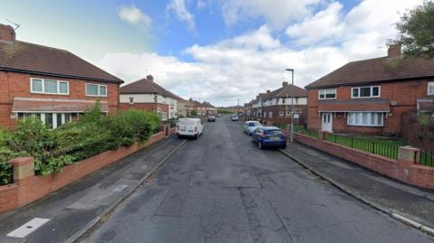 Arkley Cresent is a residential street lined with semi-detached red-bricked houses.