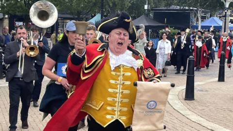 Town crier David Hinde shouting in the street