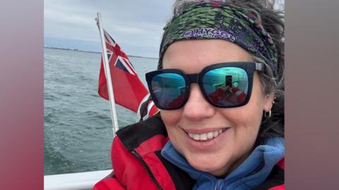 A woman taking a selfie on a boat.