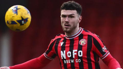 Wing-back Connor Barrett watches the ball in action for Walsall against Accrington Stanley in January.