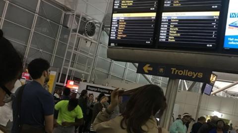 Passengers waiting for baggage at Stansted Airport