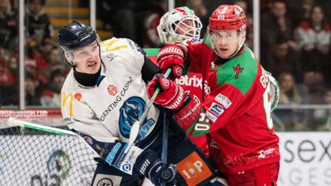 Cardiff Devils and Coventry Blaze players tussle in front of the net